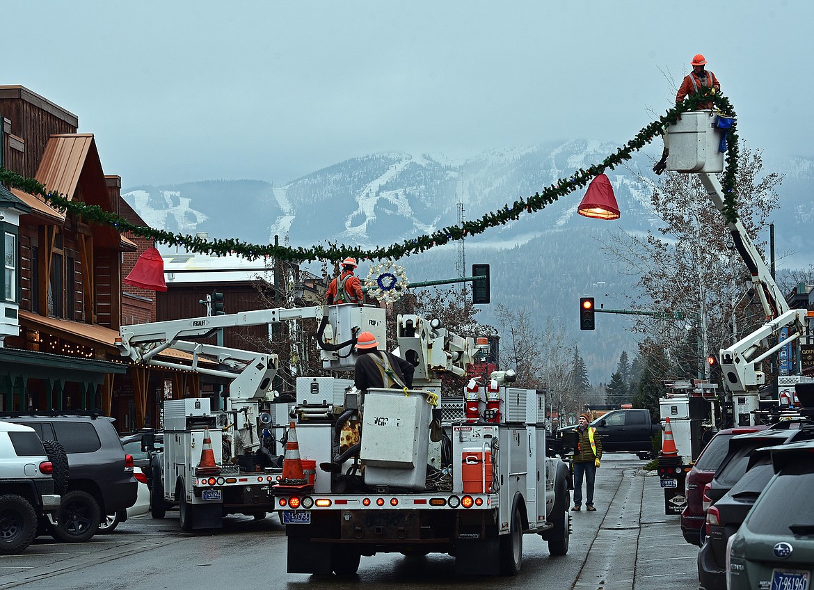 Flathead Electric Cooperative and several residents volunteered to put up Whitefish's winter decorations on Sunday. (Julie Engler/Whitefish Pilot)