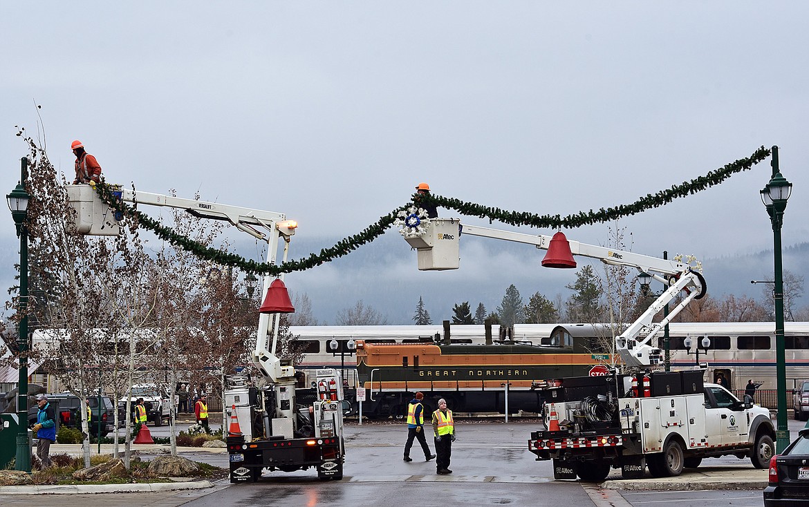 Flathead Electric Cooperative and several residents volunteered to put up Whitefish's winter decorations on Sunday. (Julie Engler/Whitefish Pilot)