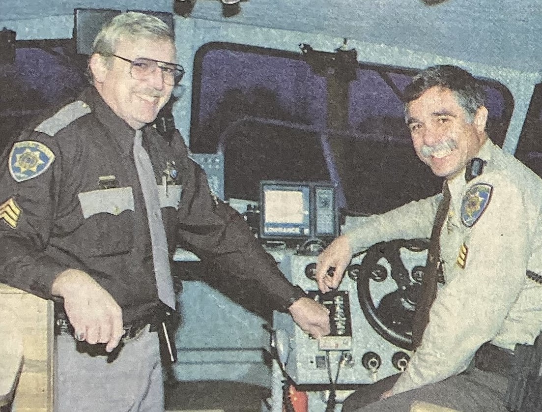 Sgt. Nile Shirley, left, turns the helm of the KCSO marine division over to Sgt. Jeff Thomas.