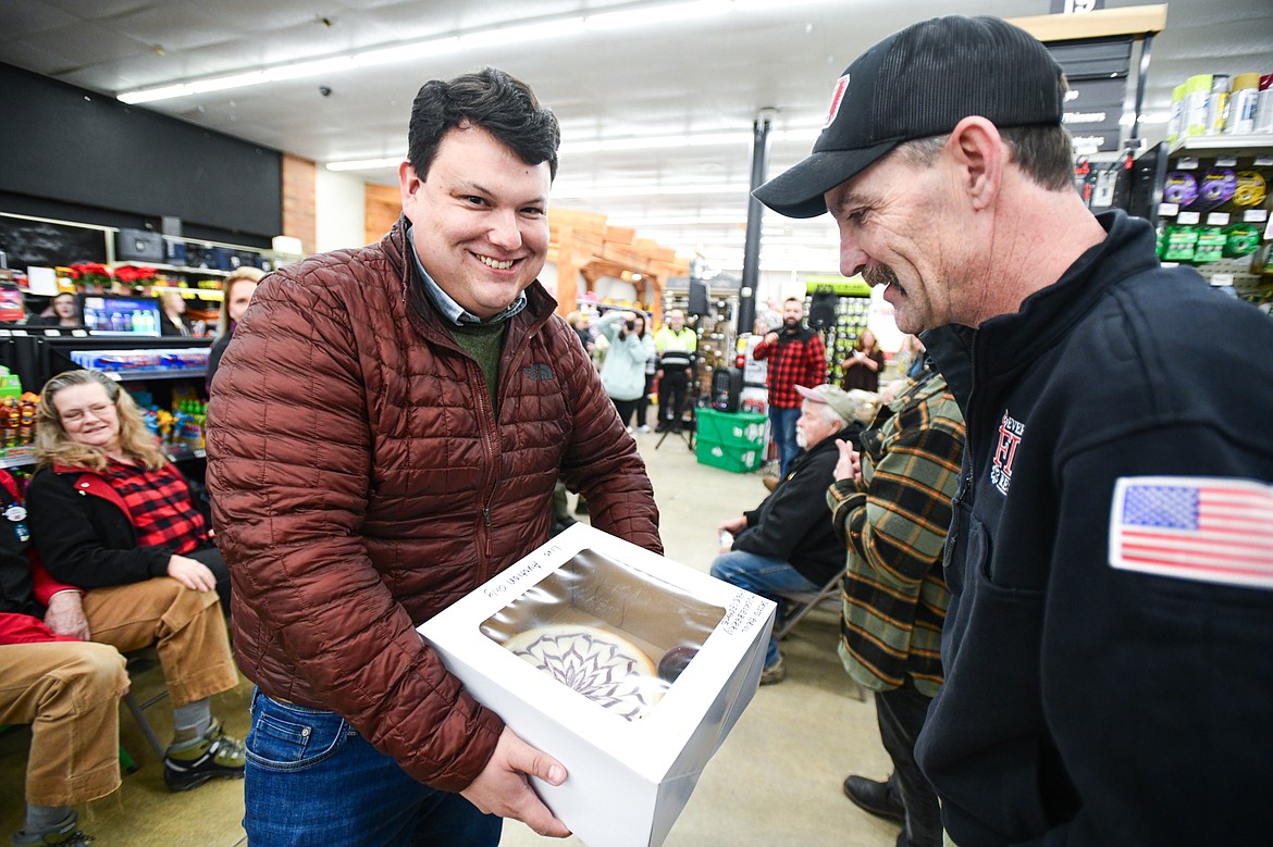Rep. Tony Brockman shows a huckleberry cheesecake made by The Desoto Grill during the live auction at the annual Light Up Evergreen & Pie Auction at Glacier Ace Hardware on Tuesday, Nov. 21. (Casey Kreider/Daily Inter Lake)