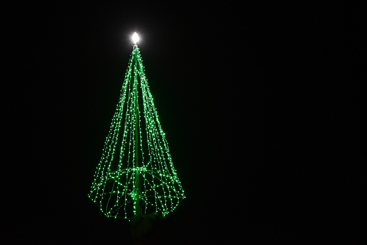 The Evergreen Christmas tree is lit and suspended from a crane outside Harmon Crane & Rigging on Tuesday, Nov. 21. (Casey Kreider/Daily Inter Lake)