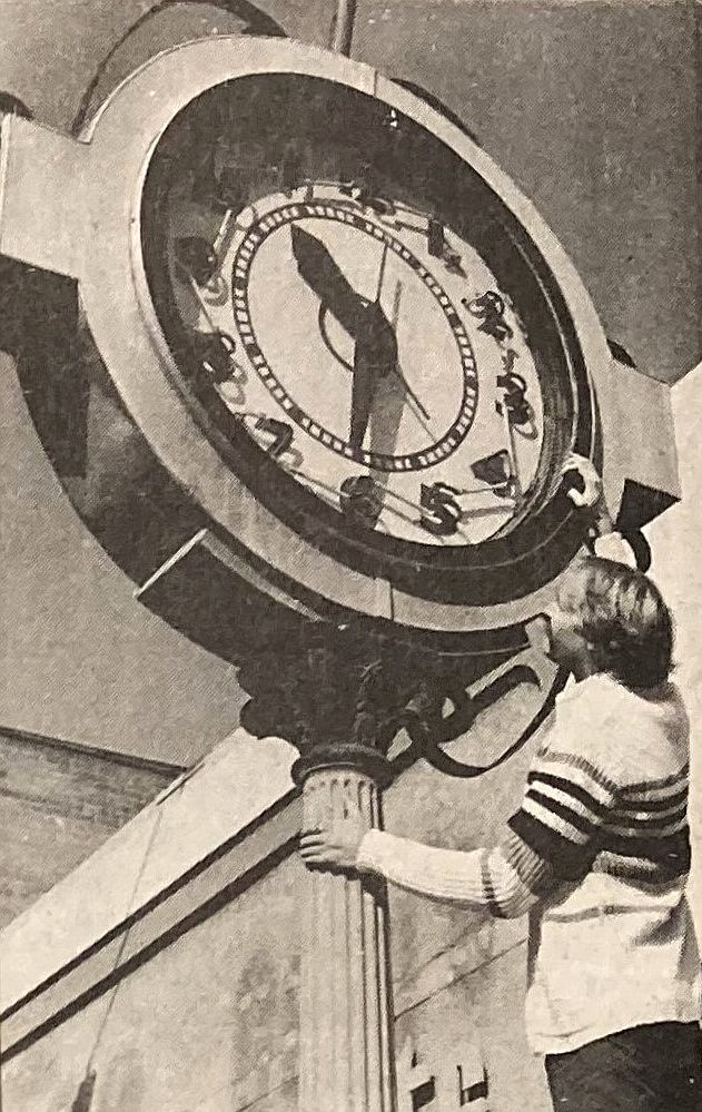 Worker Craig Graber checks the old clock before it’s taken down for repair.