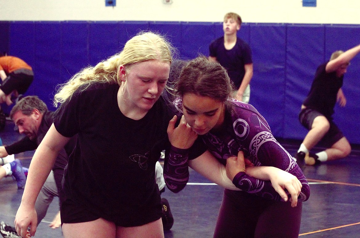 Badger wrestlers practice takedowns.