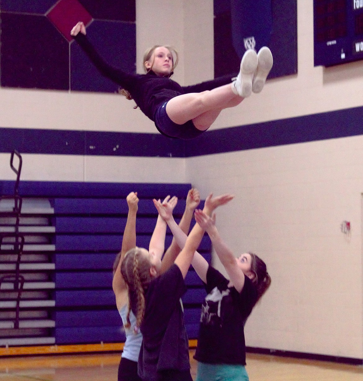 Badger cheer practices a basket-toss stunt.