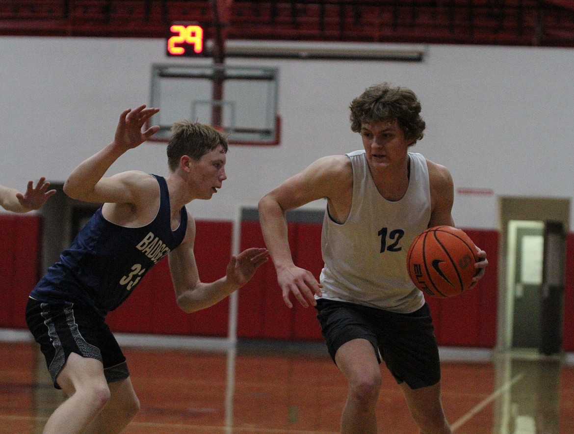 Clark Fork's Ethan Howard dribbles past Bonners Ferry's Ty Schrock.