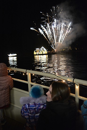 Kaela Graham and Juno watch the fireworks aboard the Mish-An-Nock during a Journey to the North Pole on Lake Coeur d'Alene.