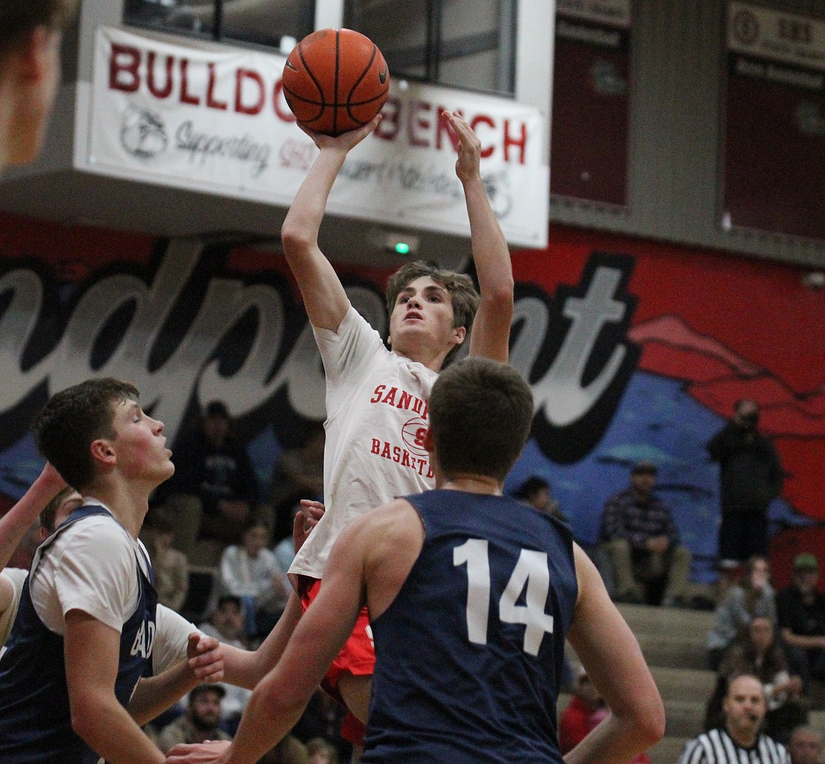 Sandpoint's Luke Leavitt shoots and scores over Bonners Ferry's Thomas Bateman.