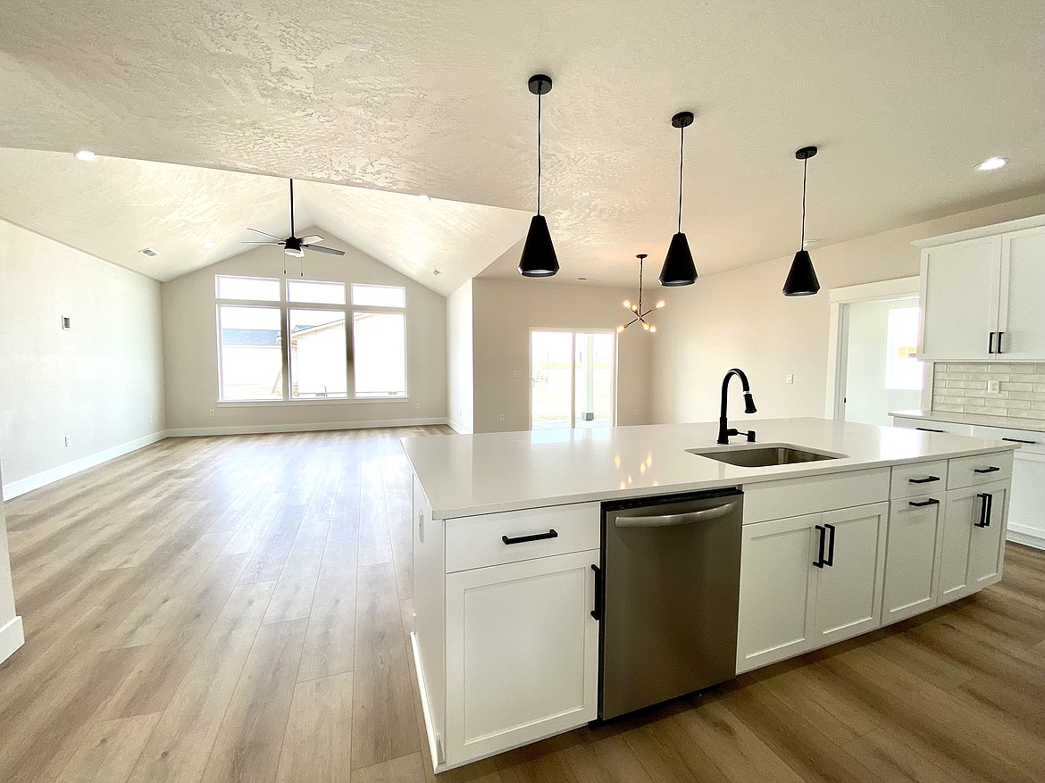 The interior of a house previously listed by Imagine Realty on the north end of Othello. The doorway on the right leads from the kitchen to the attached master bedroom with its own bathroom, closet and patio access.