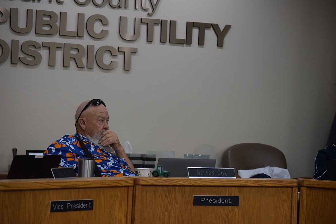 Grant County PUD Commissioner Nelson Cox considers the alternatives during a discussion on 2024 electrical rates Tuesday.