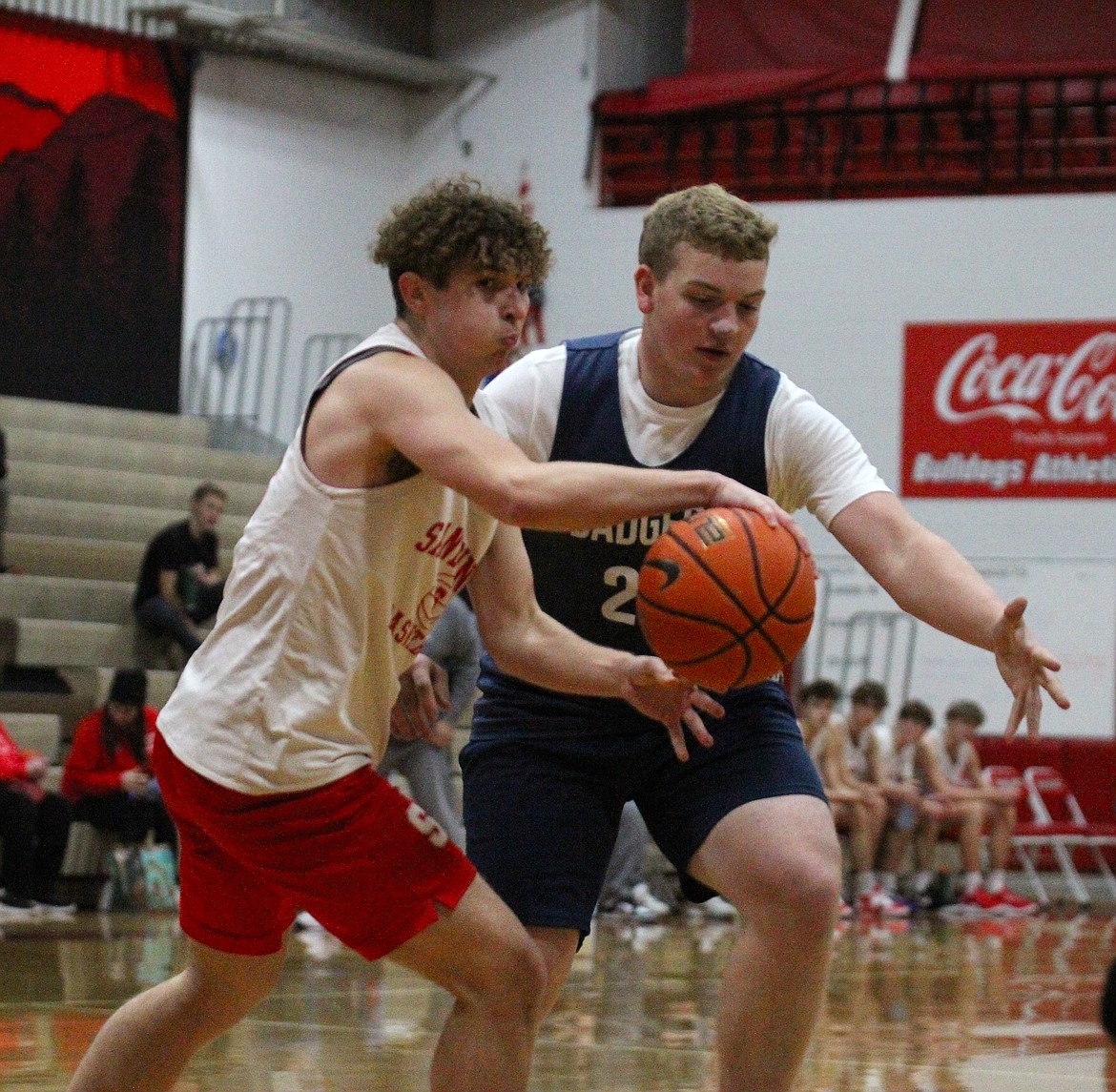 Sandpoint's Parker Childs passes to a cutting teammate while guarded by Bonners Ferry's Trey Bateman.