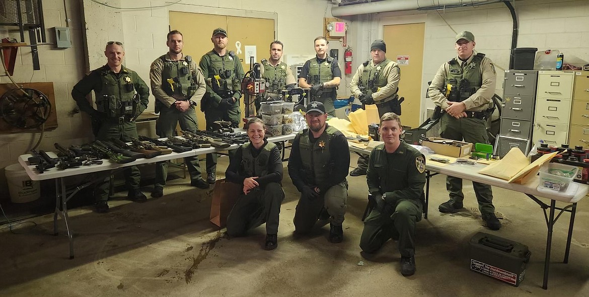 Law enforcement from the Silver Valley Drug Task Force pose with the firearms and materials seized Monday, Nov. 20.