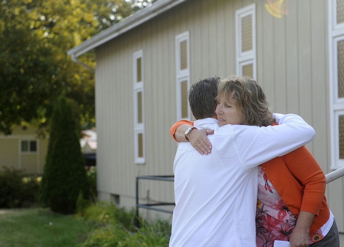Marcia Bumke of Sparrows Nest hugs Brian Tanko after touring the Kalispell building that Tanko and his wife, Victoria, donated to the organization in this 2014 file photo. (Daily Inter Lake file)