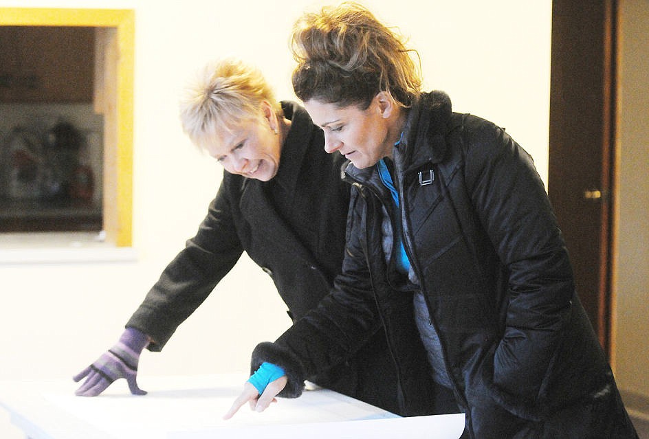 Current Sparrow's Nest and former vice chair Linda Kaps, left, and former board member Stacey Schultz look over the floor plans for the renovation of the organization's shelter for homeless teens in Kalispell in this file photo. (Aaric Bryan/Daily Inter Lake file)