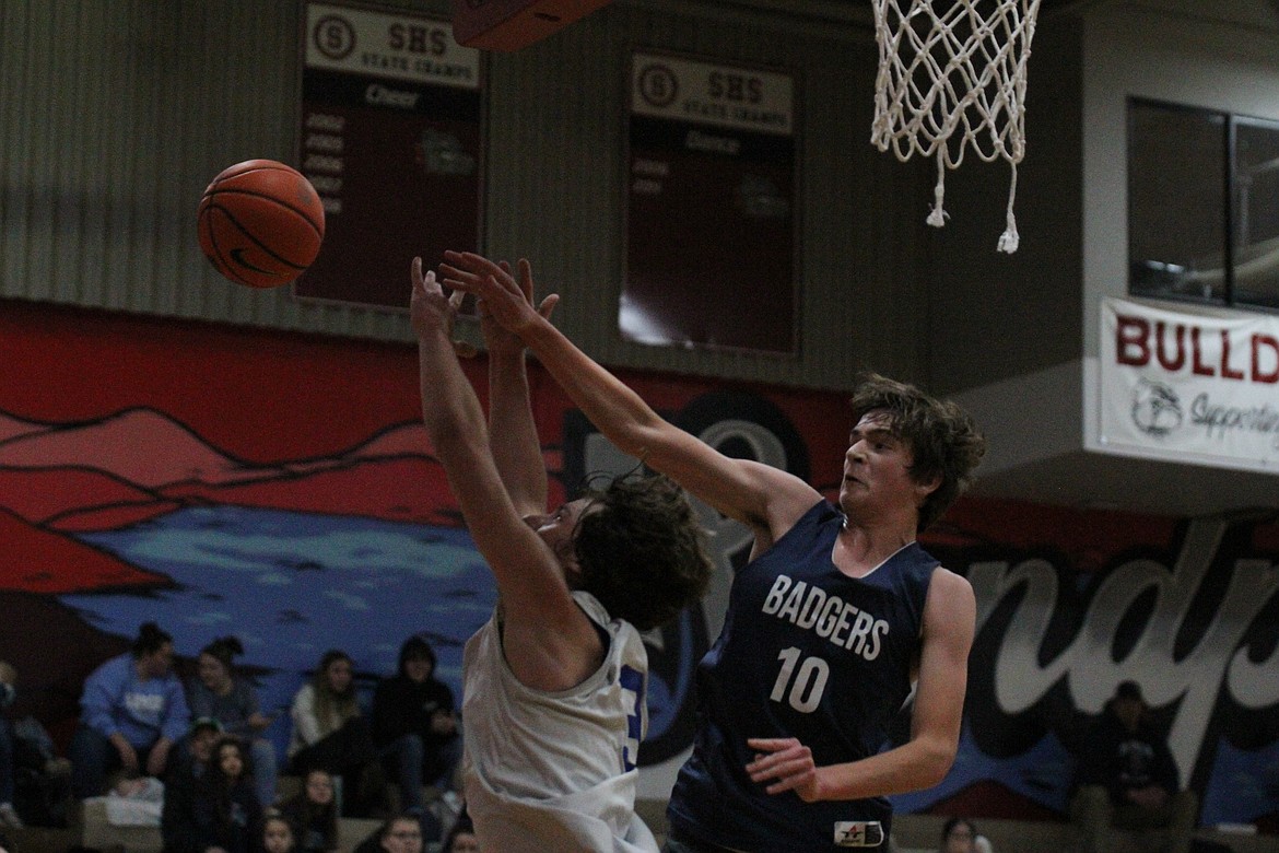 Bonners Ferry's Wyatt Smith blocks Clark Fork's Evrett Montgomery on a fast break.