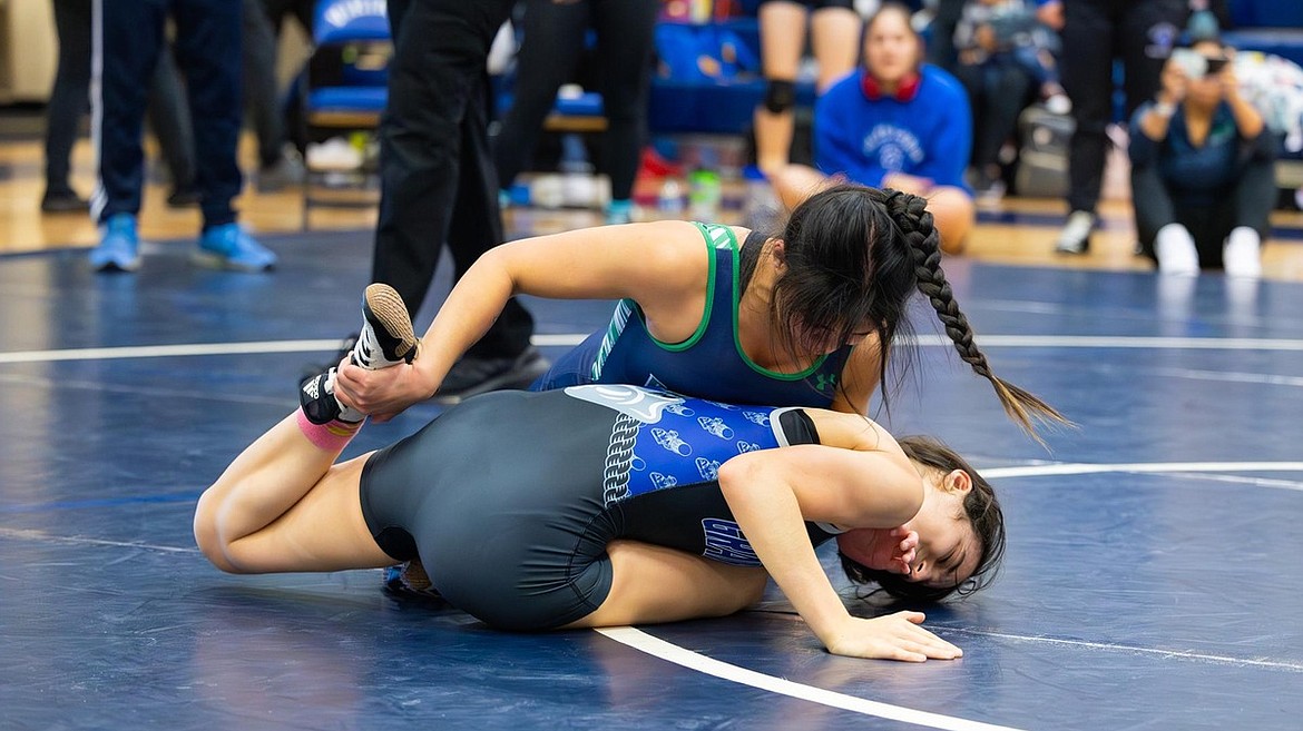 A Vikings wrestler pushes an opponent to the mat during competition at the Big Bend Scramble.