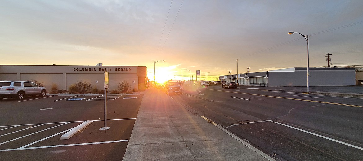 The sun sets Tuesday outside the Columbia Basin Herald office in Moses Lake. Weather this weekend is expected to be chilly but clear.