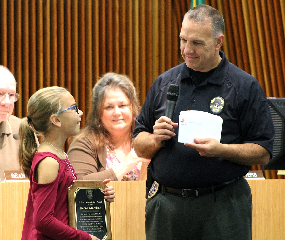 Moses Lake Police Department Chief Kevin Fuhr honors then-9-year-old Kenna Morrison during a 2018 city council meeting for her fundraising efforts to establish a second K-9 team at the MLPD. Kenna raised more than $20,000 by selling her homemade slime at the Moses Lake Farmers Market over the summer and soliciting donations from more than 60 local businesses.