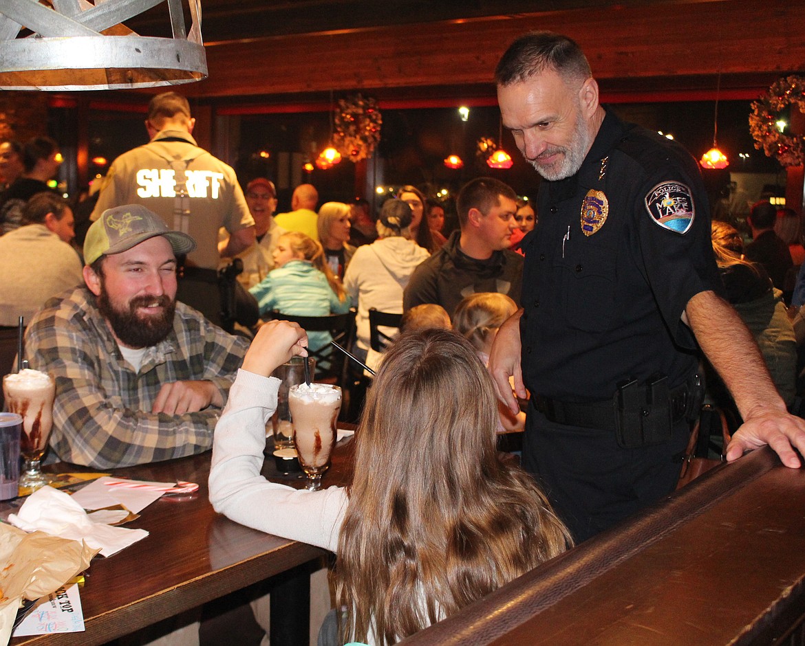 Moses Lake Police Chief Kevin Fuhr talks with customers during Tip A Cop night at the Rock Top restaurant in 2019. Money raised through Tip A Cop goes to the Shop with a Cop program.