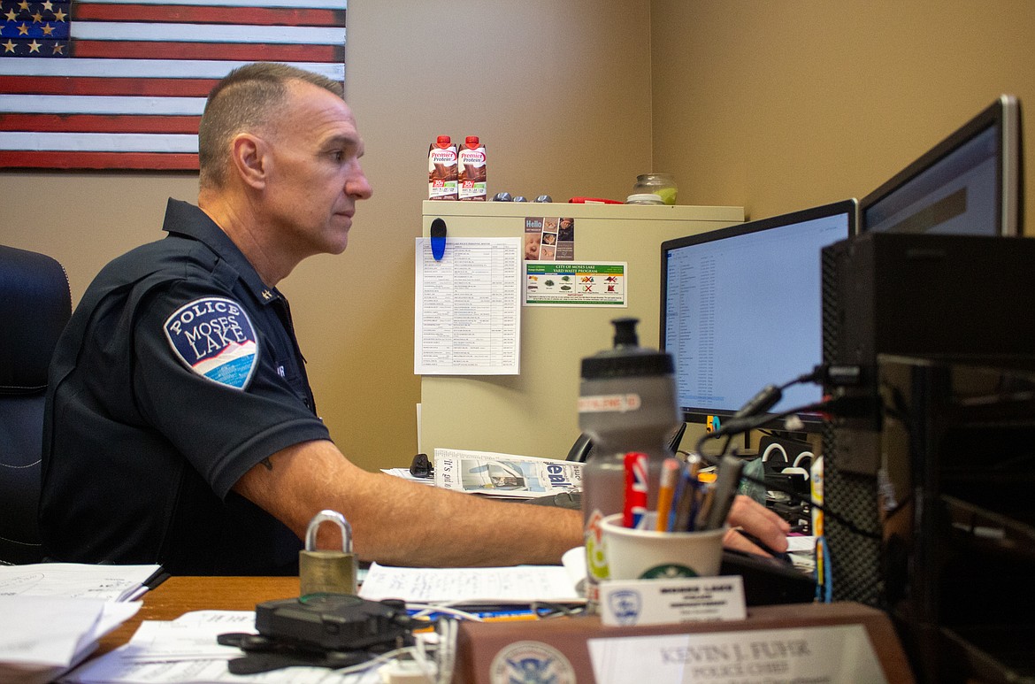 Moses Lake police Chief Kevin Fuhr works in his office last Thursday in 2020. Fuhr had discussed his views on the calls for police reform taking place across the country.