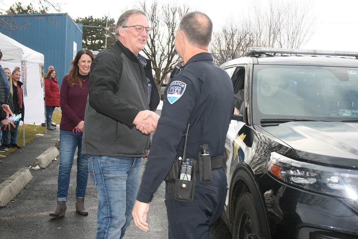 Retiring Royal City Police Chief Darin Smith, left, gets a retirement handshake in February of 2021 from Moses Lake Police Department Chief Kevin Fuhr, right.