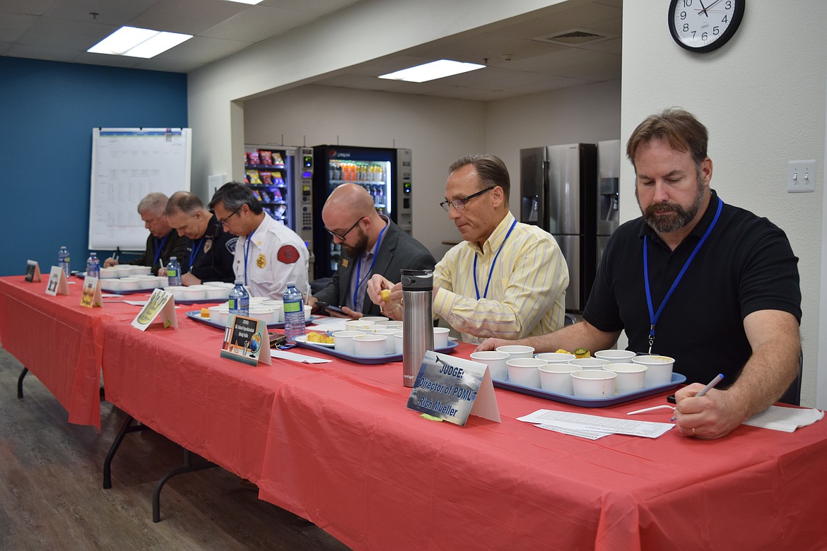 Port of Moses Lake Executive Director Don Kersey, Moses Lake Police Chief Kevin Fuhr, Moses Lake Deputy Fire Chief Pete Kunjara, Moses Lake Mayor Don Myers, Moses Lake School Superintendent Monty Sabin and Grant County International Airport Director Rich Mueller busily judge a chili cookoff at Greenpoint Technologies on in mid-April.