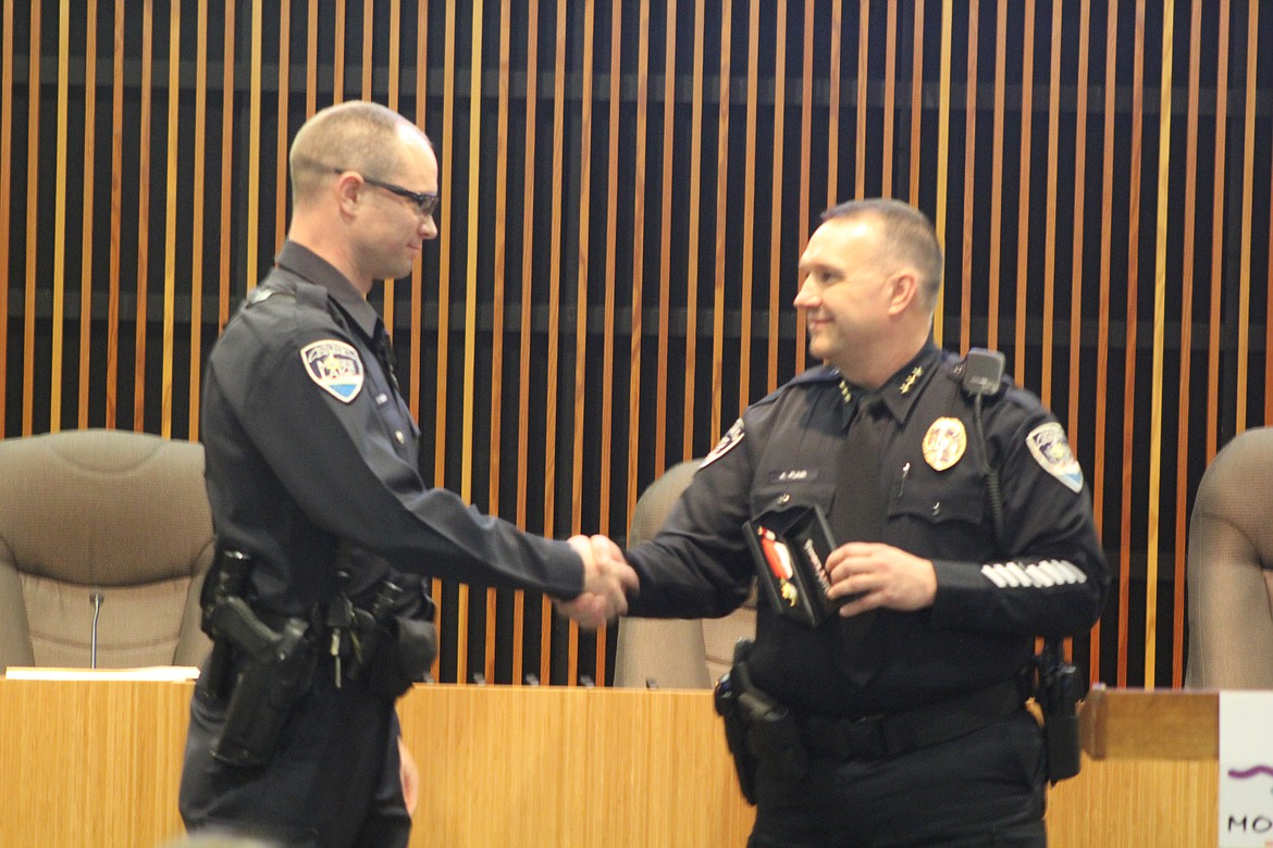 Moses Lake Police Department Chief Kevin Fuhr, right, awards officer Caleb Welsh, left, the Life Saving Award in January of 2017.