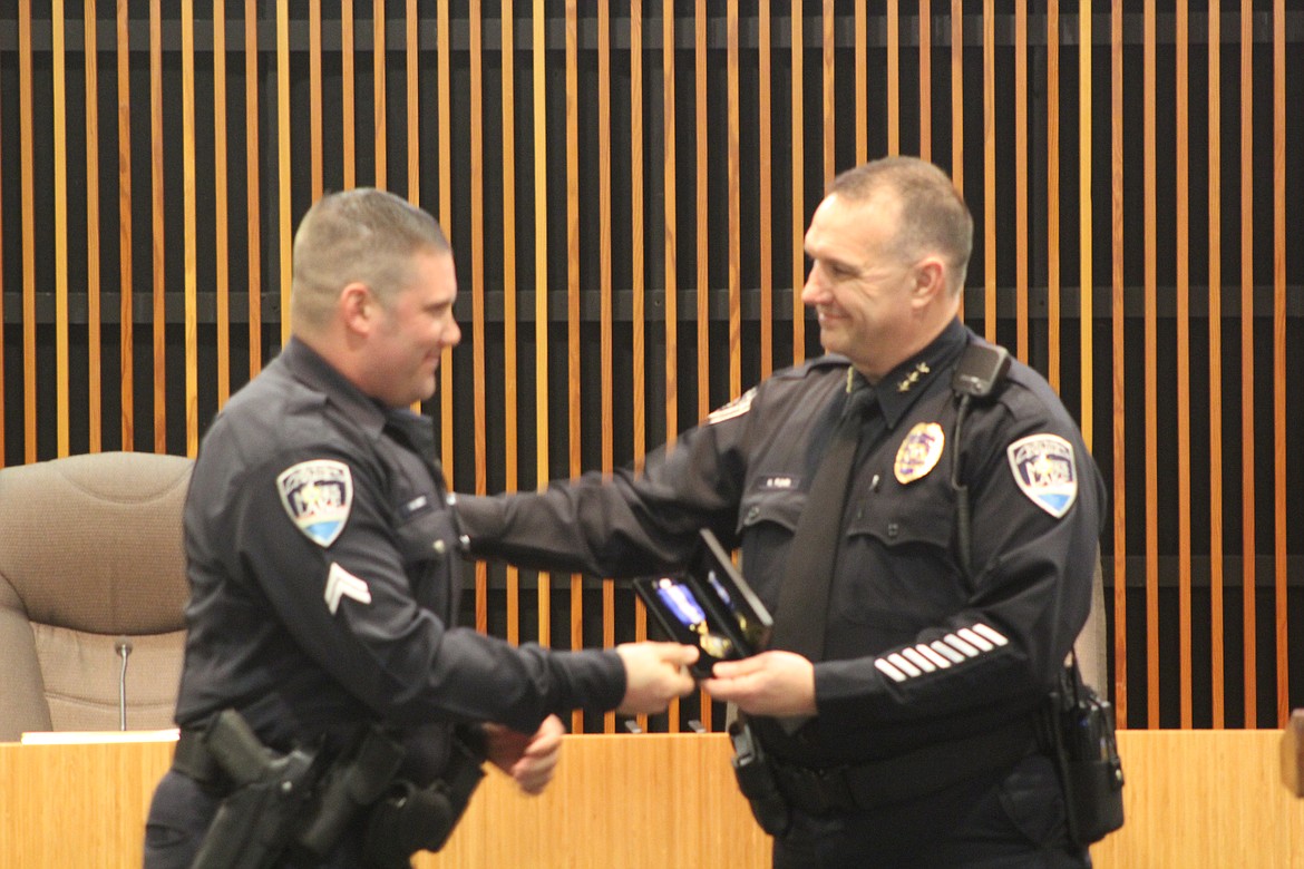 Moses Lake Police Department Chief Kevin Fuhr, right, awards Cpl. Aaron Hintz, left, the Meritorious Service Award. Fuhr has said that mentoring officers to serve and lead is important for the success of the department.