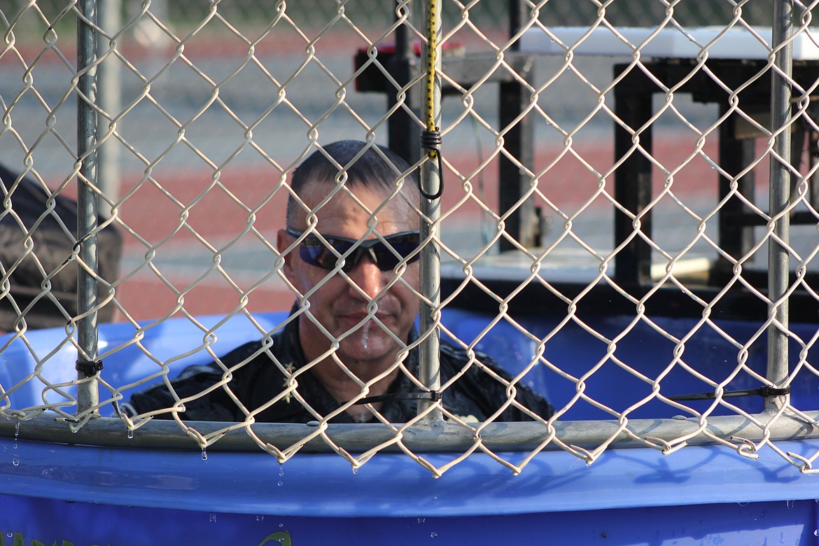 Moses Lake Police Department Chief Kevin Fuhr rises out of the water after getting dunked during National Night Out 2018. He regularly volunteered for community activities that helped raise money for a variety of causes.