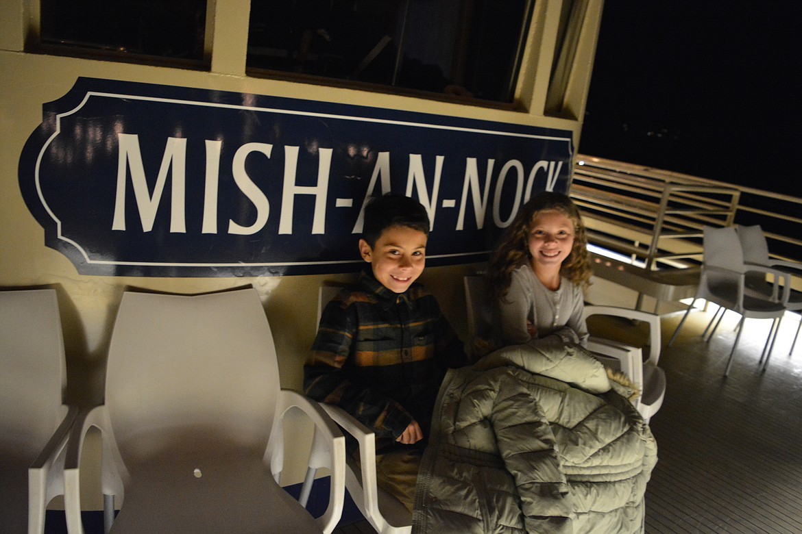 Kids huddle together to keep warm in front of the bridge where the captain of the Mish-An-Nock steered the ship.