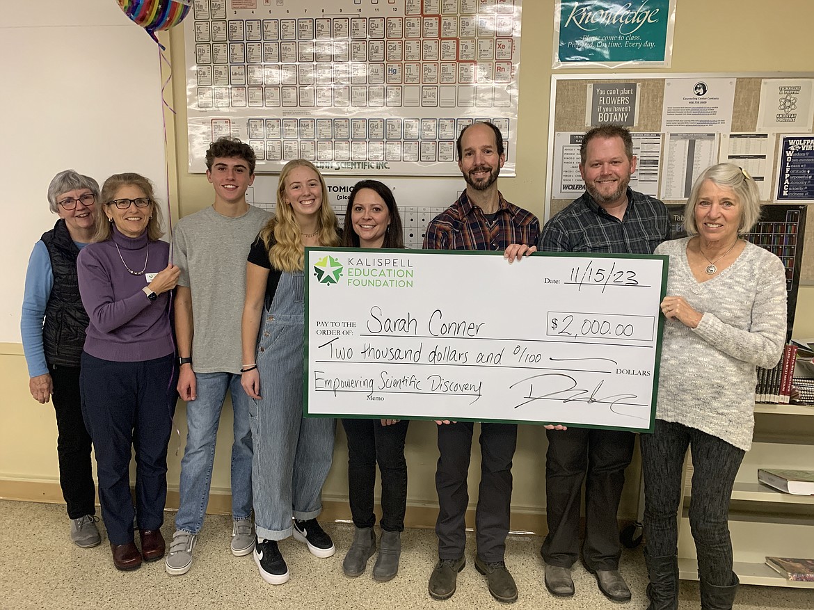 Glacier High School science teacher Sarah Conner is presented with a $2,000 grant to support the holding the school's first science fair by Kalispell Education Foundation board members, student board members and a corporate partner. From left to right, Sue Brown, Lynn Dykstra, Creed Wiley, Elise Strobel, Sarah Conner, Josh Kroll, Shane Jacobs and Carol Santa. (Courtesy photo)