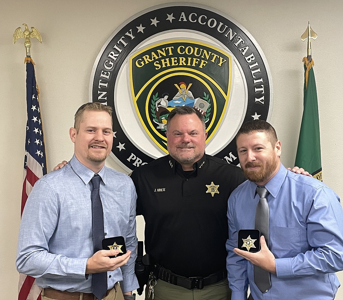 Grant County Sheriff Joe Kriete, center, administered the oath of office to Sgt. Seth Henkel and Deputy Nick Williams Monday.