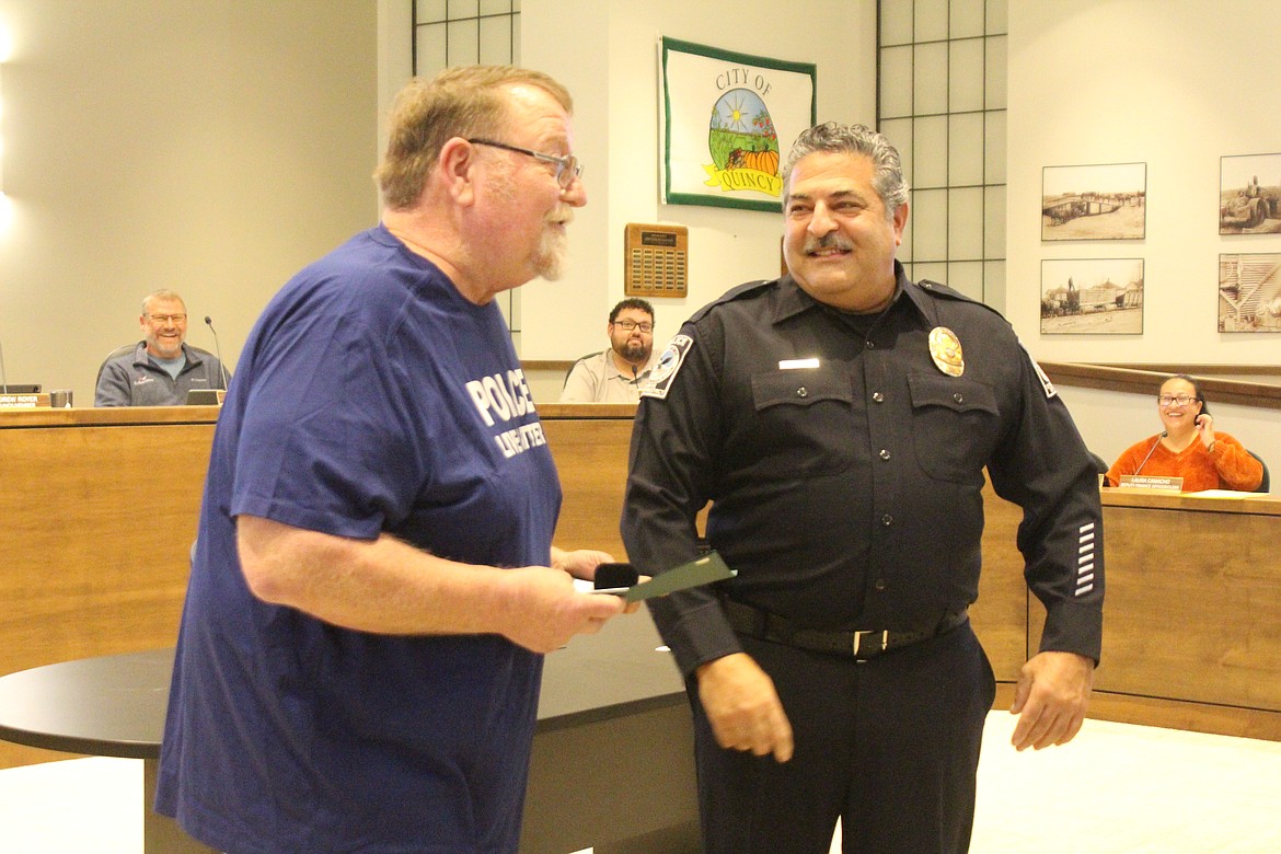 Quincy Mayor Paul Worley, left, presents a certificate of appreciation to Quincy Police Department Officer Sal Mancini for 20 years with the city.