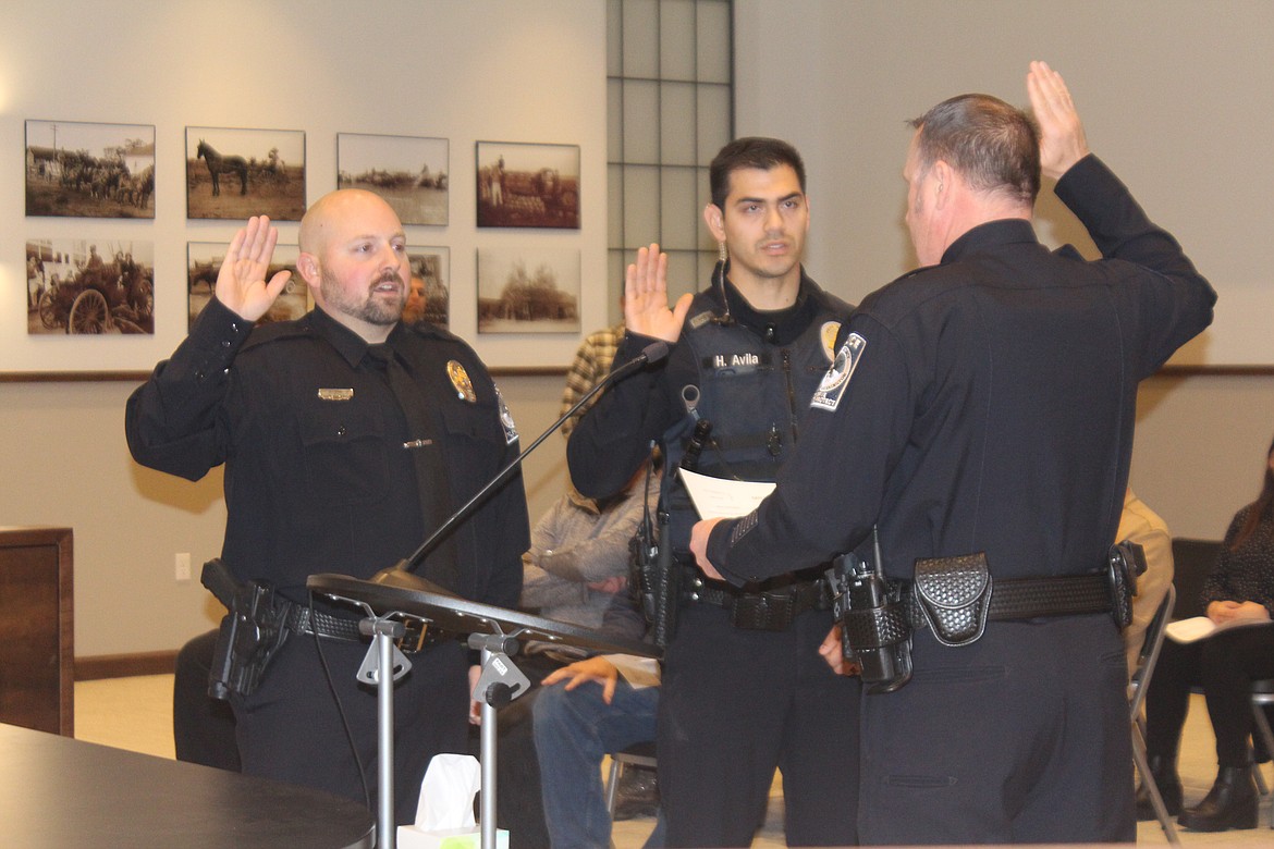 New Quincy Police Department officers Jesse King, left, and Hector Avila, center, are sworn in by QPD Chief Ryan Green, right, during the Quincy City Council meeting Tuesday.