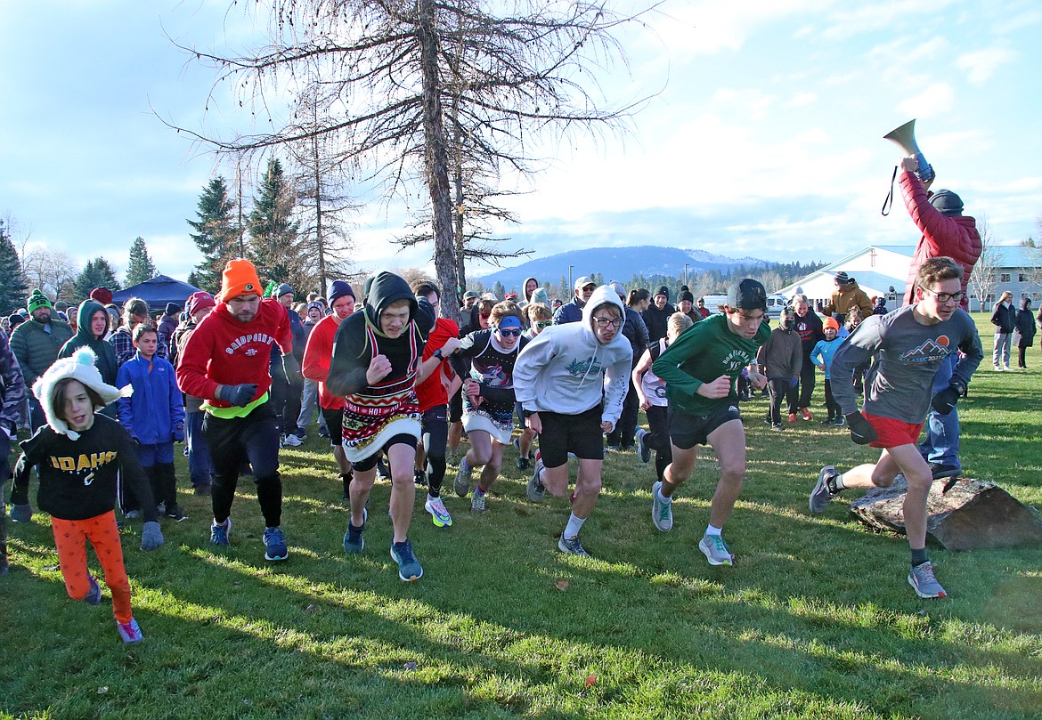 Members of the Sandpoint High School cross-country team leads the pack as runners take off at the start of Thursday's Turkey Trot fun run.