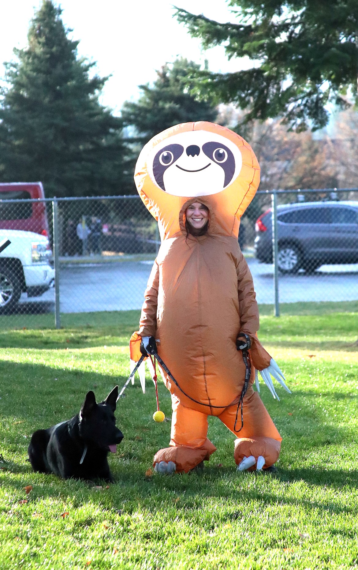 A Bonner County residents smiles as she walks forward to receive her pie after being selected as having the best costume during Thursday's annual Turkey Trot fun run.