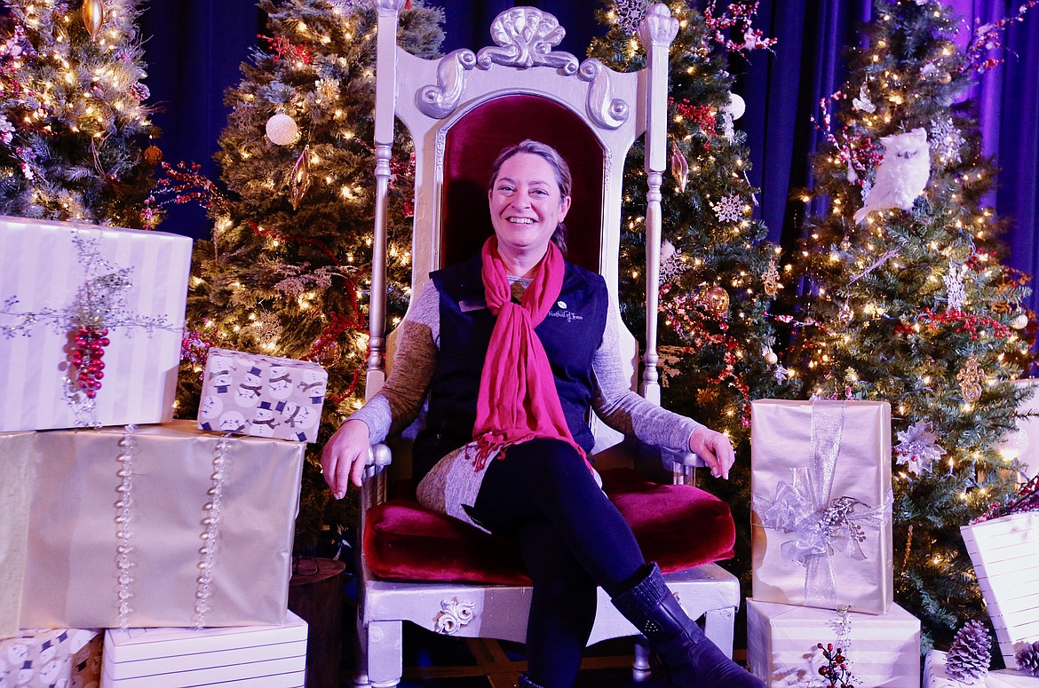 Kootenai Health Foundation President Cara Neilsen took a turn on Santa’s throne Friday, as volunteers put the finishing touches on the Festival of Trees displays.