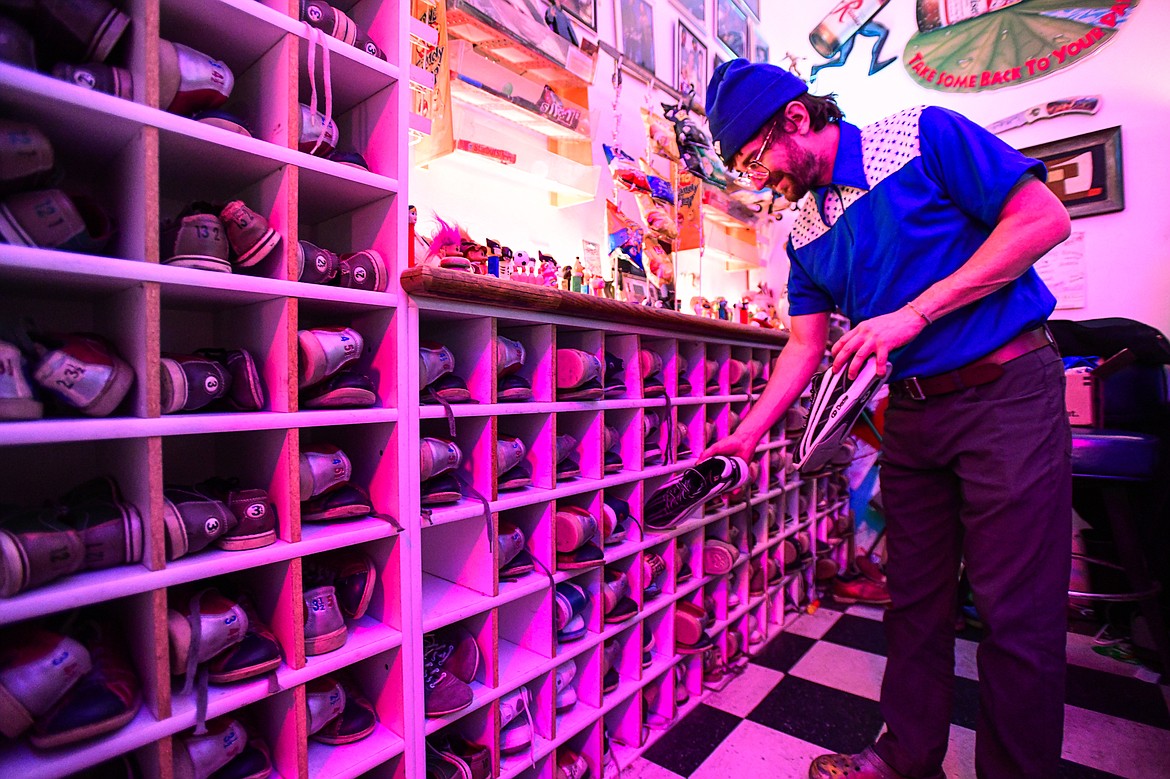 Gavin Gray selects a pair of bowling shoes for a customer at Glacier Lanes in Columbia Falls on Friday, Nov. 24. (Casey Kreider/Daily Inter Lake)