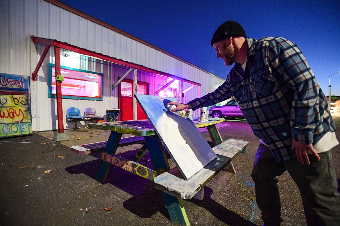 Barak Evans, a friend of the Larsons, works on a piece of spray-paint art for the alley at Glacier Lanes in Columbia Falls on Friday, Nov. 24. (Casey Kreider/Daily Inter Lake)