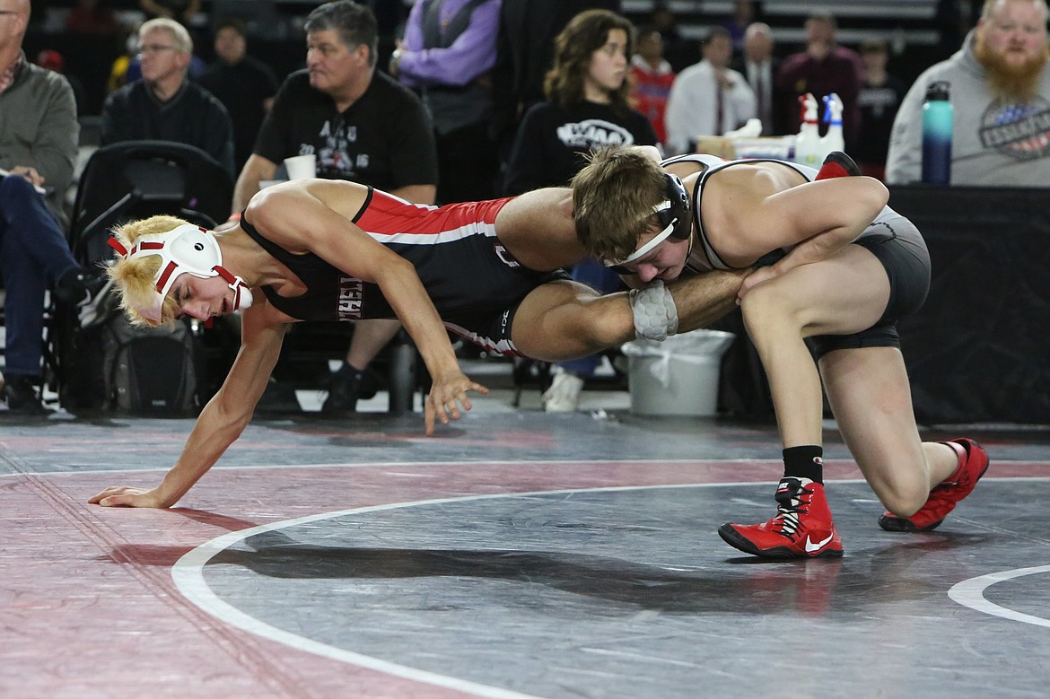 Othello senior Isaac Campos, left, took second in the 2A 113-pound bracket at the Mat Classic.