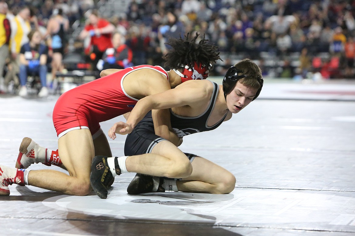 Othello sophomore Mason Russell, right, looks for an escape. Russell placed third in the 2A 120-pound bracket.