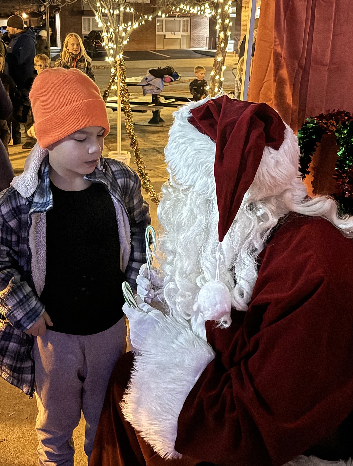 Santa Claus listens as a young fan shares what they would like for Christmas as the Jolly Old Elf came to Sandpoint on Friday for the town's annual tree lighting ceremony.