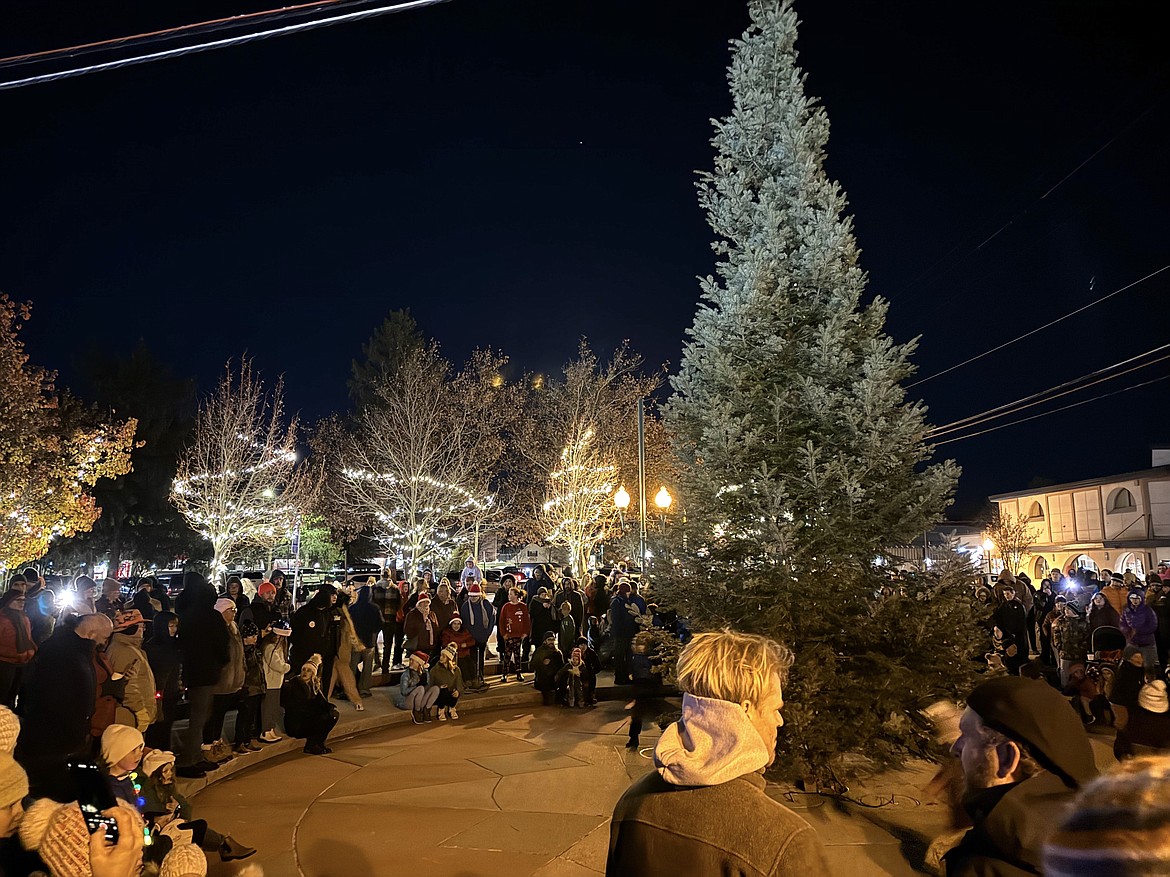 The community gathers around the town Christmas tree at the start of Friday's annual tree lighting ceremony.