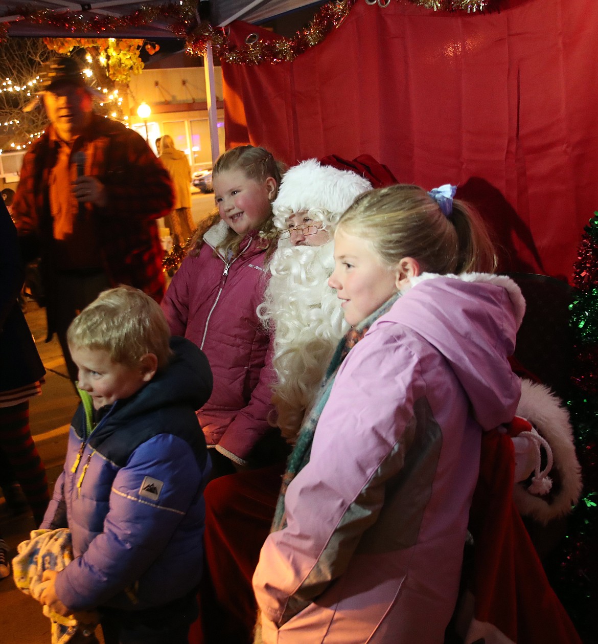 Santa Claus poses for a photo Friday with some fans as the Jolly Old Elf visited Sandpoint for the town's annual tree lighting ceremony.