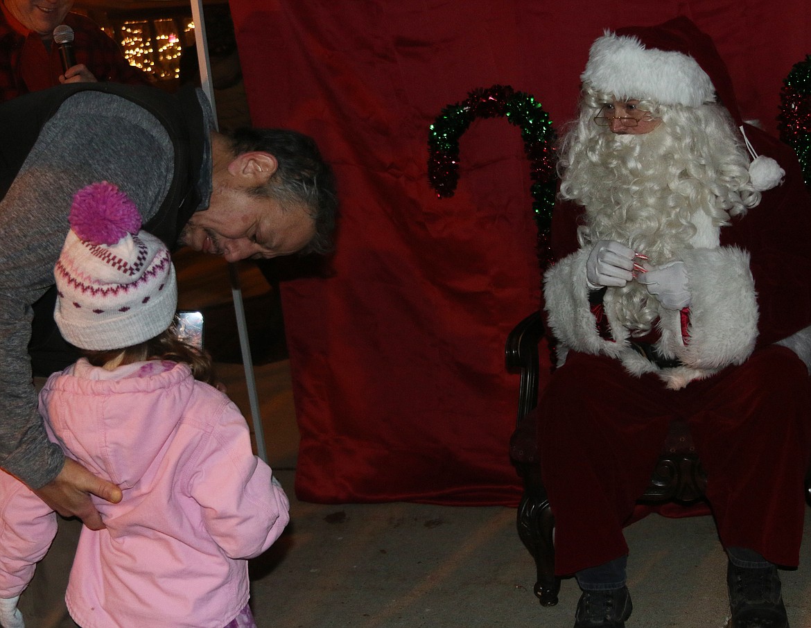 Santa Claus listens as a young fan shares what they would like for Christmas as the Jolly Old Elf came to Sandpoint on Friday for the town's annual tree lighting ceremony.