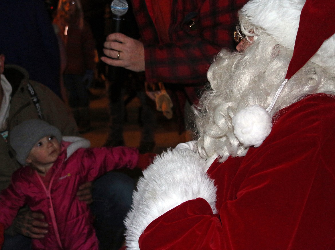 Santa Claus spends time with fans of all ages during a visit to the community's annual tree lighting ceremony Friday.