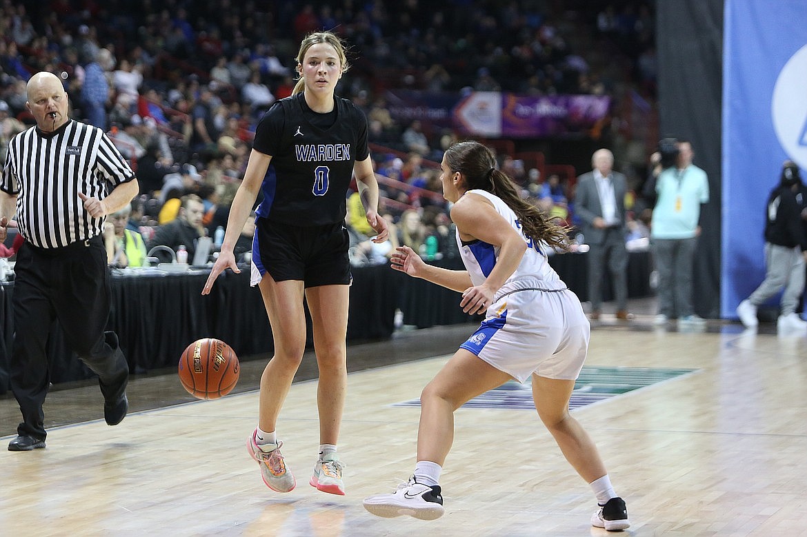 Warden senior Lauryn Madsen, left, looks for an open teammate against Colfax in the 2B Girls State Basketball Tournament semifinals last season.