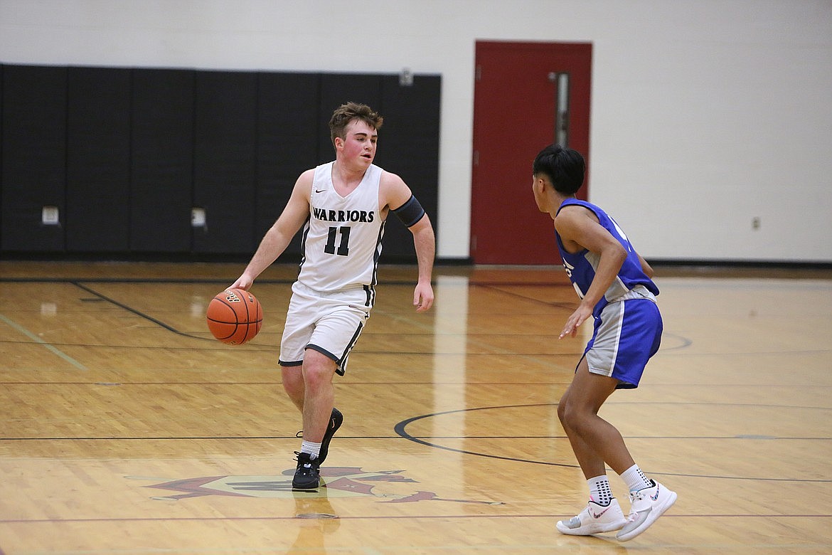 ACH junior Carter Pitts (11) looks past a Manson defender.