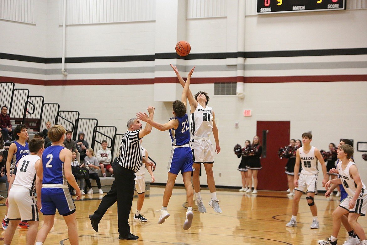 ACH sophomore Brady Roberts (21) leaps up for the opening tipoff against Manson last season.