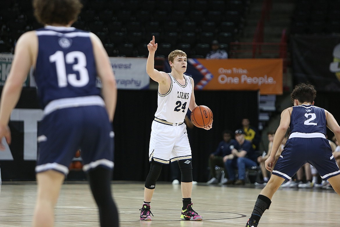 MLCA/CCS sophomore James Robertson (24) brings the ball up the floor during a game in the 1B Boys State Basketball Tournament in Spokane.