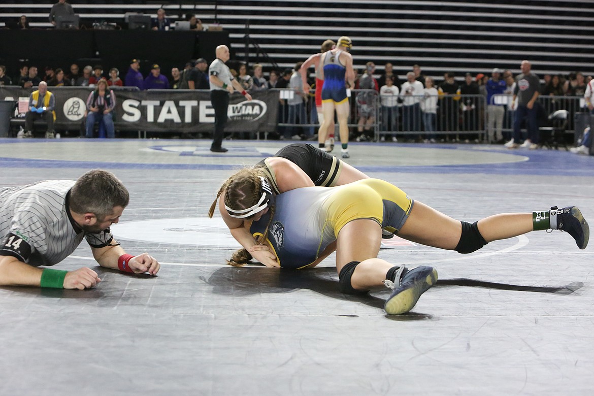 Royal junior Lauren Jenks, top, looks to keep her opponent down at the Mat Classic in Tacoma.